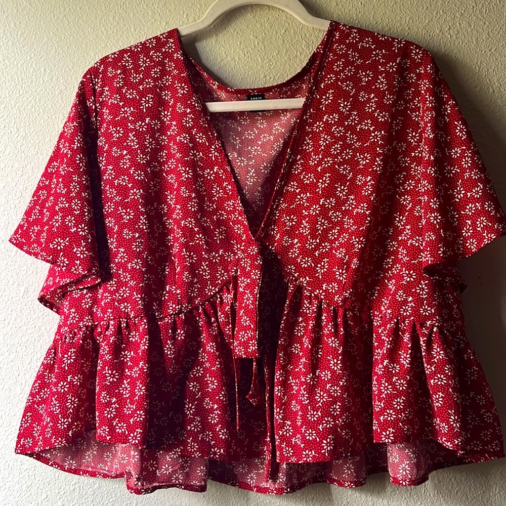 Red short sleeve blouse with white daisy’s.